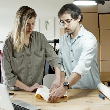 Team members packing orders in an online store's workspace, exemplifying efficient teamwork.